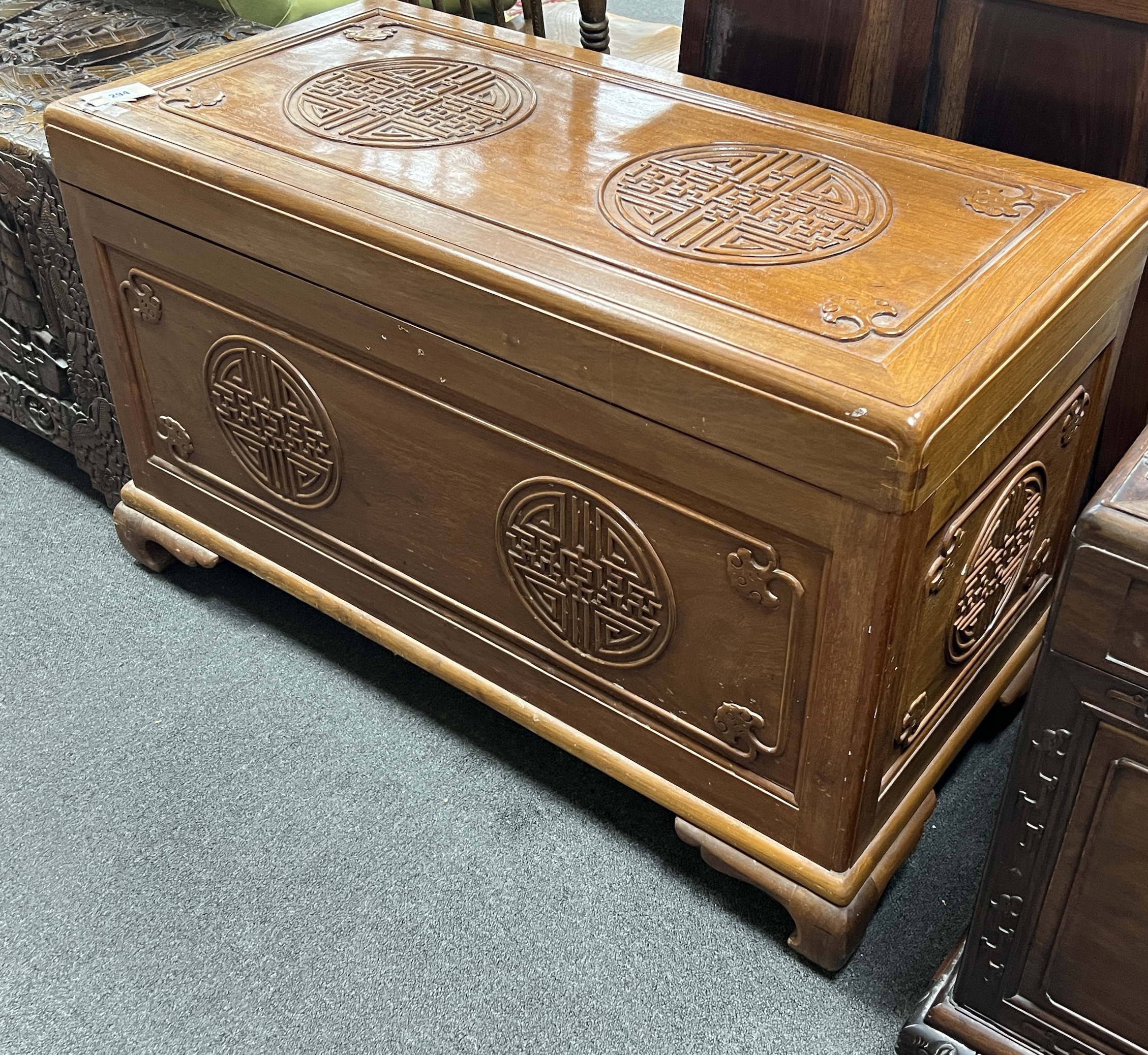 An Asian lacquered carved camphorwood trunk, length 101cm, depth 49cm, height 61cm